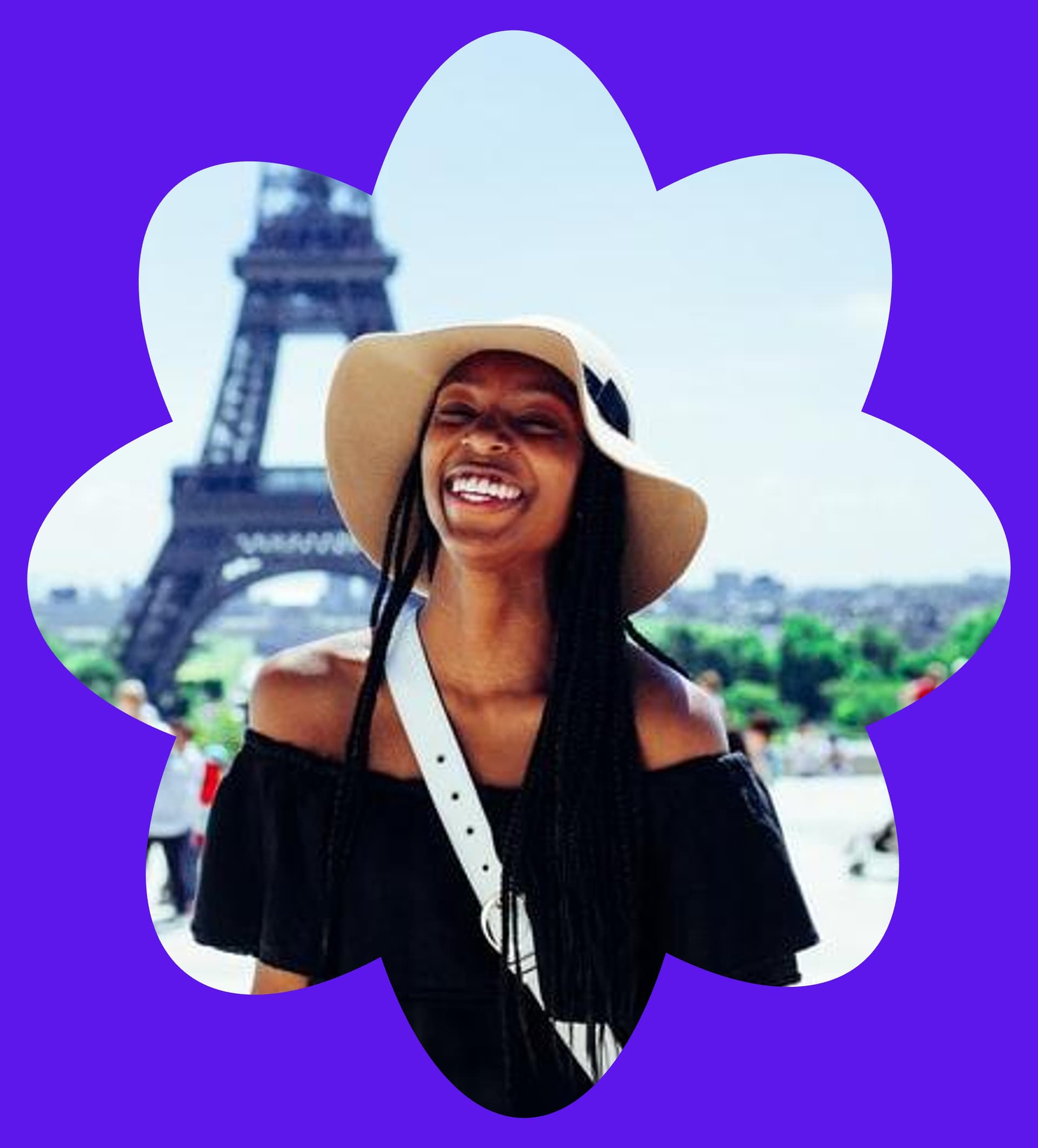 A Plu traveler laughing in front of the Eiffel Tower